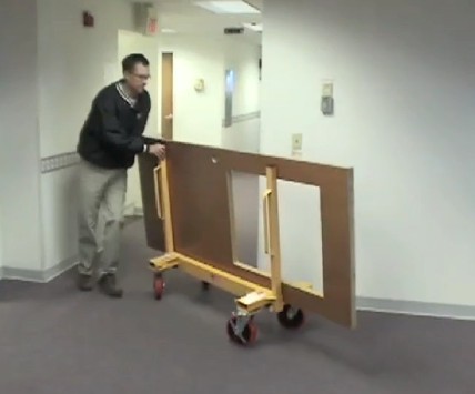 A slab buggy being used on a construction site to move large panels.