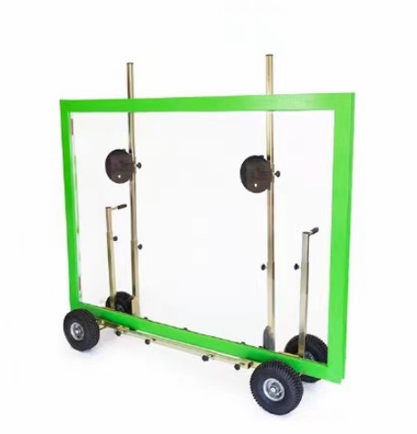 A worker easily moving a large glass panel with a slab buggy