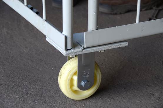A close-up image of a roll cage container's caster wheel.
