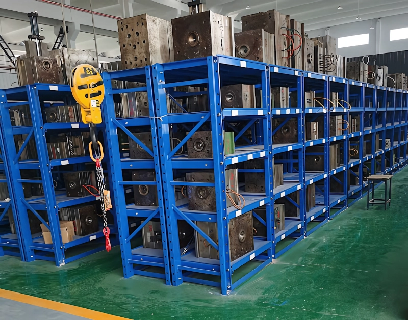 A heavy duty mold racking system with a crane ready to lift a mold.